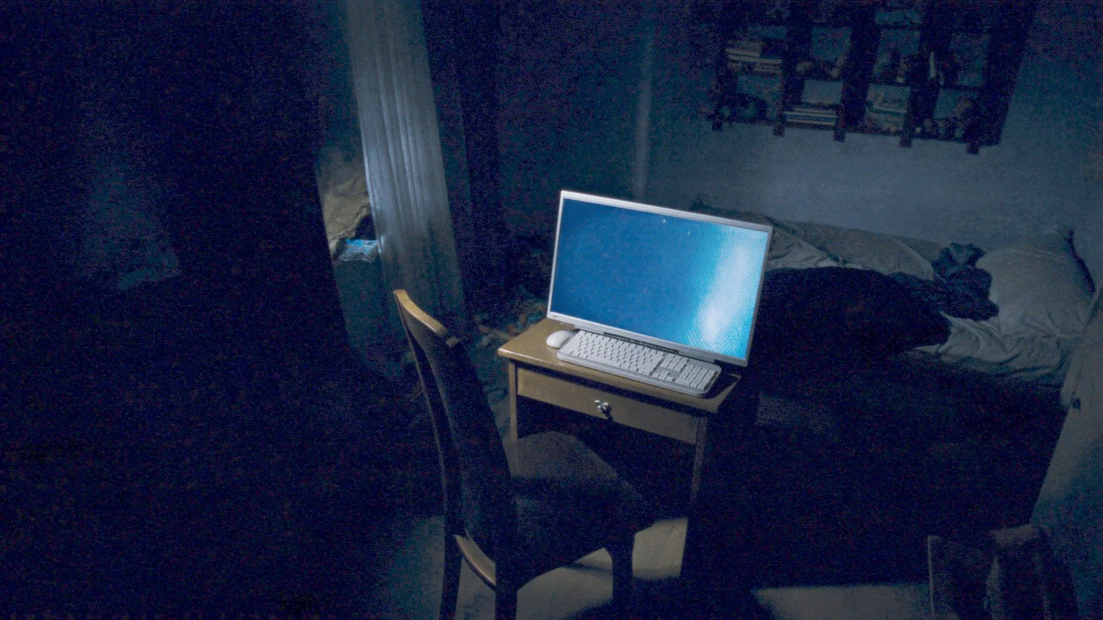 An empty child&rsquo;s bedroom at night lit only by the glow of a computer screen