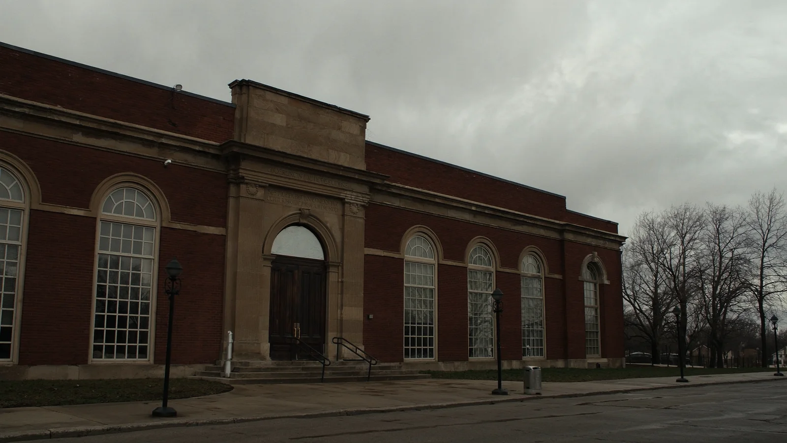 The closed doors of a diocesan chancery administration building on an overcast morning