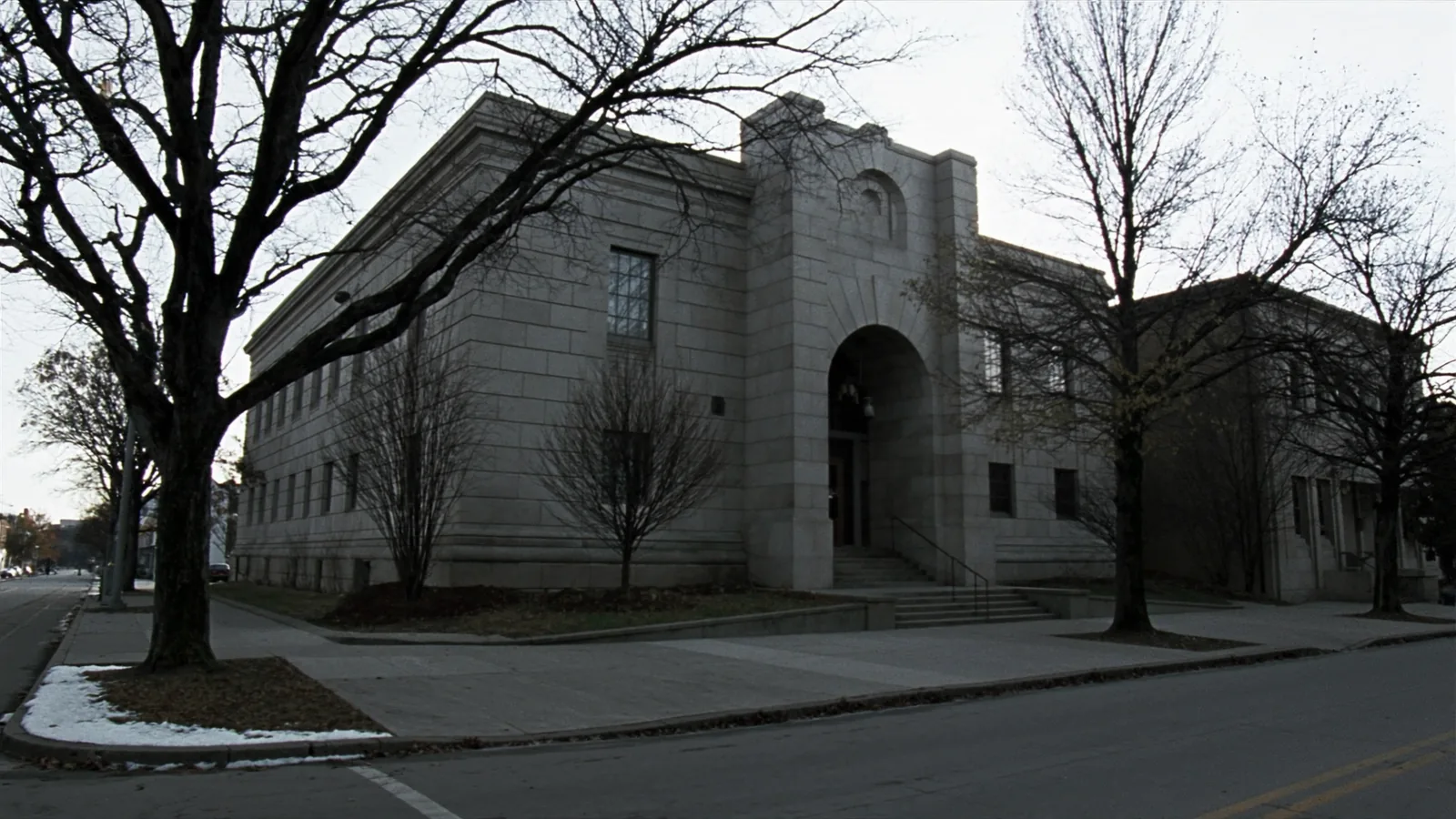 Burlington diocese bankruptcy dismissal: a granite courthouse on a bare autumn street