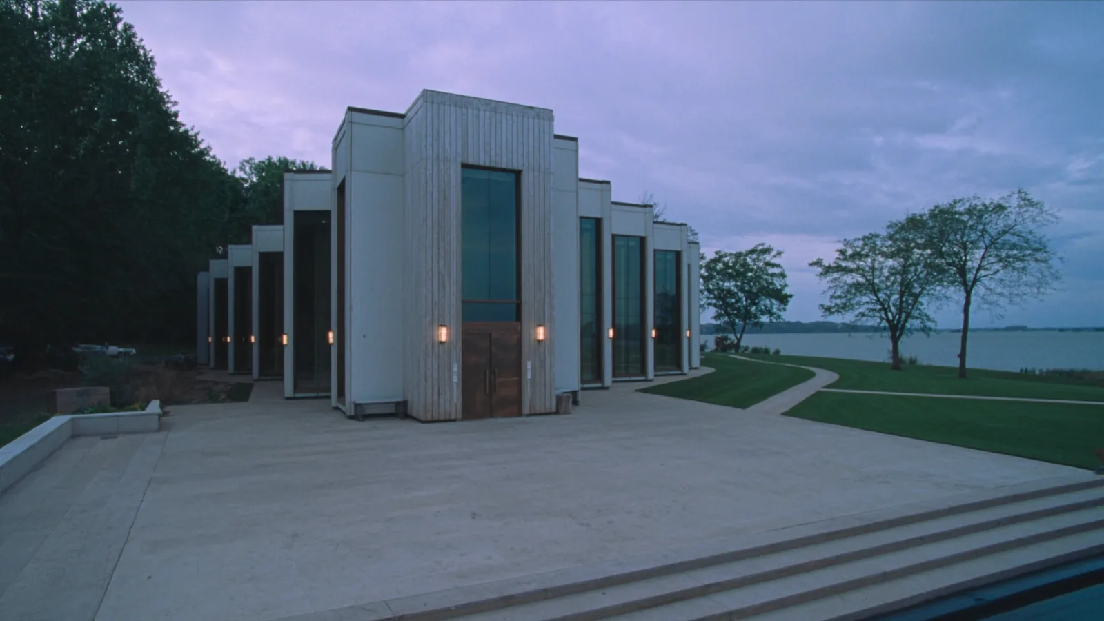 Oakland diocese bankruptcy plan: a modern cathedral of timber and glass beside a lake at dusk