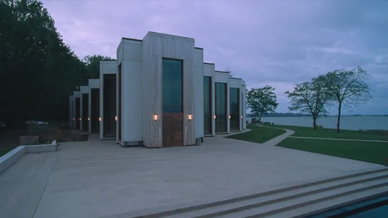 Oakland diocese bankruptcy plan: a modern cathedral of timber and glass beside a lake at dusk