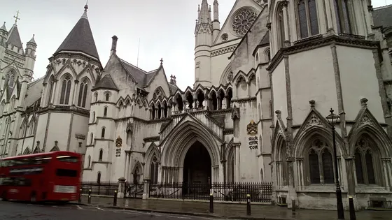 The stone facade of a Victorian Gothic law courts building in London